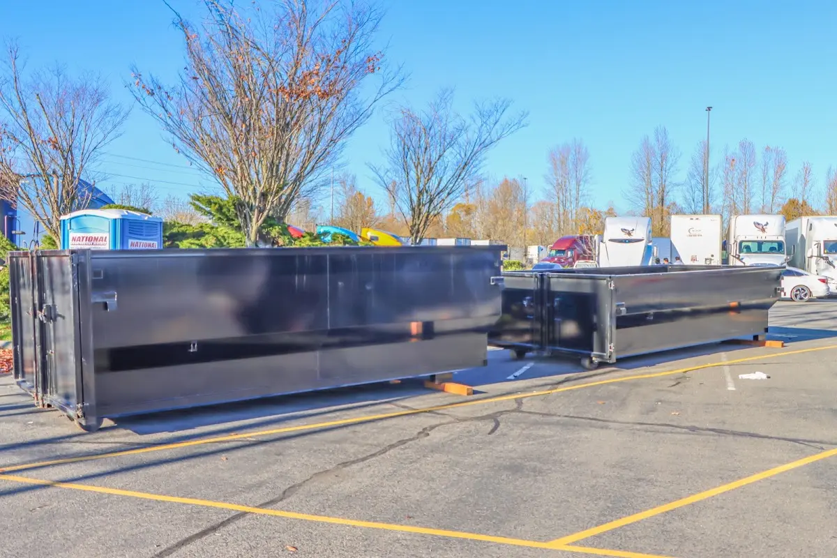 Professional dumpster rental service with roll-off container on residential driveway in June Park